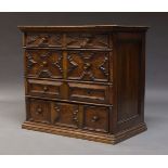 An oak chest of drawers, 17th Century and later, with four drawers, with geometric moulding, on