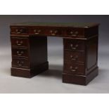 A George III style mahogany pedestal desk, late 20th Century, the rectangular top inset green