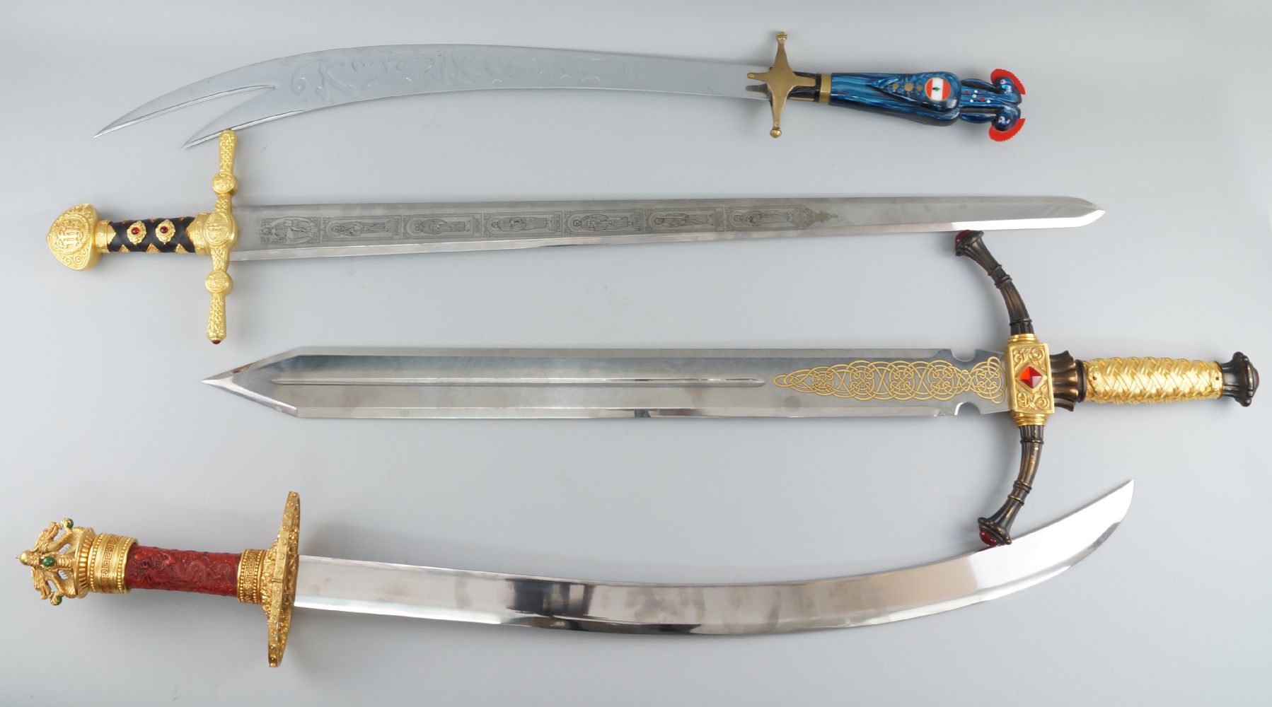 A group of four fantasy display swords, of modern manufacture, to comprise a scimitar type sword