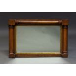 A Regency mahogany and parcel gilt wall mirror, of rectangular form, the mirror plate within gilt