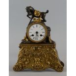 A French gilt bronze and bronze mantel clock, 19th century, the case mounted with a horse and dog on