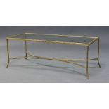 A brass and glass coffee table, c.1970, the rectangular glass top, on cast leaf motif frame, with