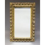 A Florentine style gilt wood wall mirror, mid 20th Century, of rectangular form, with pierced