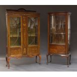 An Edwardian mahogany and marquetry inlaid display cabinet, the moulded top with shaped raised back,