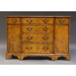 A George III style walnut and crossbanded breakfront chest of drawers, late 20th Century, the