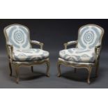 A pair of Louis XV style grey painted fauteuils, early to mid 20th Century, the cartouche shape