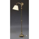 An brass standard lamp, early to mid 20th Century, with pierced grape vine decoration and silk