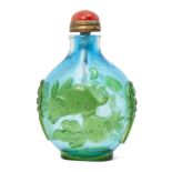 A Chinese Peking glass cameo snuff bottle, late Qing dynasty, carved in green over blue with a