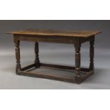 An oak refectory table, early to mid 18th Century, the three plank top with cleated ends, above