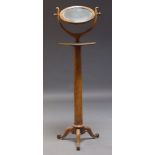 A Victorian mahogany shaving mirror, the circular mirror, on curved swing frame support, above