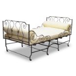 A French cast iron folding campaign bed, third quarter 19th Century, with wrought iron scrollwork