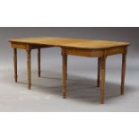 A Victorian mahogany dining table, the rounded rectangular top, with one additional leaf, raised