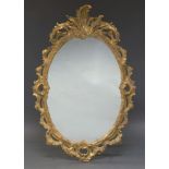 A giltwood Rococo taste wall mirror, late 19th, early 20th Century, of oval form, with pierced