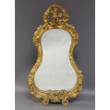 A gilt gesso wall mirror in the Rococo taste, late 19th Century, of waisted form, the pierced