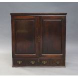 A George III mahogany side cabinet, the moulded cornice above two panelled doors, enclosing three