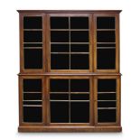 A George III mahogany bookcase, the moulded cornice above two glazed and brass mounted doors,