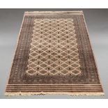 A Pakistan Bokhara woolen carpet, the central reserve set with stepped lozenge-shaped motifs on a