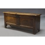 An oak coffer, 18th Century, the hinged lid enclosing storage space and candle box, with panelled