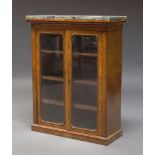 An early Victorian burr walnut pier cabinet, with green marble top, above two glazed doors enclosing