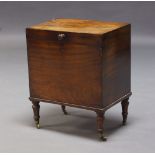 A Victorian mahogany cellarette, the rectangular hinged lid, enclosing storage space, raised on