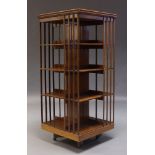 A large Edwardian mahogany revolving bookcase, the square top, above four tiers of shelves, raised