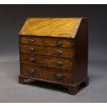 A mahogany bureau, 19th Century, the fall enclosing an arrangement of pigeon holes and drawers,