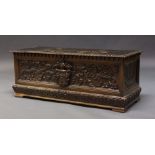 An Italian carved Cassone, late 19th, early 20th Century, the hinged lid enclosing storage space,