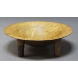 A Fijian hardwood bowl, on four cylindrical legs, 62cm diameterPlease refer to department for