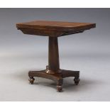 A Regency mahogany tea table, with fold over top, above shaped frieze on tapering cylindrical column