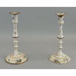 A pair of Bilston enamel candlesticks, c 1750, decorated with floral sprays and to the domed bases