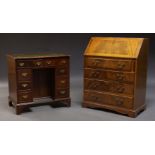 A George II style mahogany kneehole desk, late 20th Century, the rectangular top inset with green