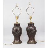 A pair of Japanese bronze vases, late 19th/early 20th century, of baluster form, moulded in relief
