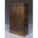 A stained oak tambour cabinet, mid 20th Century, with two tambour fronted compartments, enclosing