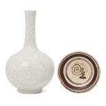 A Chinese Ying Qing porcelain bottle vase and a Cizhou type dish, the bottle vase carved with