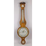 An Edwardian George III style inlaid wheel barometer, with a brass urn finial and broken arch