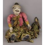 A marionette puppet of an Indonesian man, 19th/20th century, 77cm high, together with a small doll