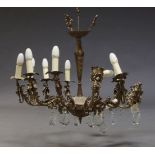 A Continental brass twelve-light chandelier, late 20th century, the scroll branches terminating with