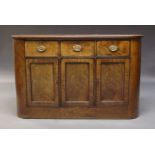 A Regency mahogany bow front sideboard, with three frieze drawers above three cupboard doors,