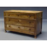 A French walnut commode, second half 19th Century, with three long drawers, raised on squat bun
