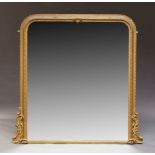 A Victorian gilt wood and gesso over mantel mirror, of arched form, with floral moulding to border