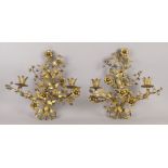 A pair of two light gilt metal wall lights, 20th century, entwined with flowers and leaves to the