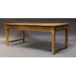 A pine farmhouse table, late 19th Century, the rectangular top, above plain frieze, with drawer to