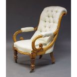 A Victorian walnut button back armchair, the curved back above scrolling armrests, upholstered in