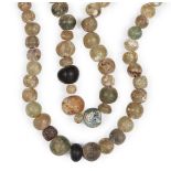 Two Roman glass bead necklaces, 2nd-8th century, comprised of round clear glass beads, one with an