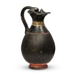 An Etruscan red and black glazed pottery jug with serpent head handle, circa 6th century B.C.,