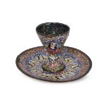 A Qajar gilt and enamelled copper cup and saucer, Iran, 19th century, the cup on a spreading foot