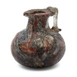 A Roman miniature glass jug, 2nd-4th century A.D., with red and periwinkle coloured streaks on black