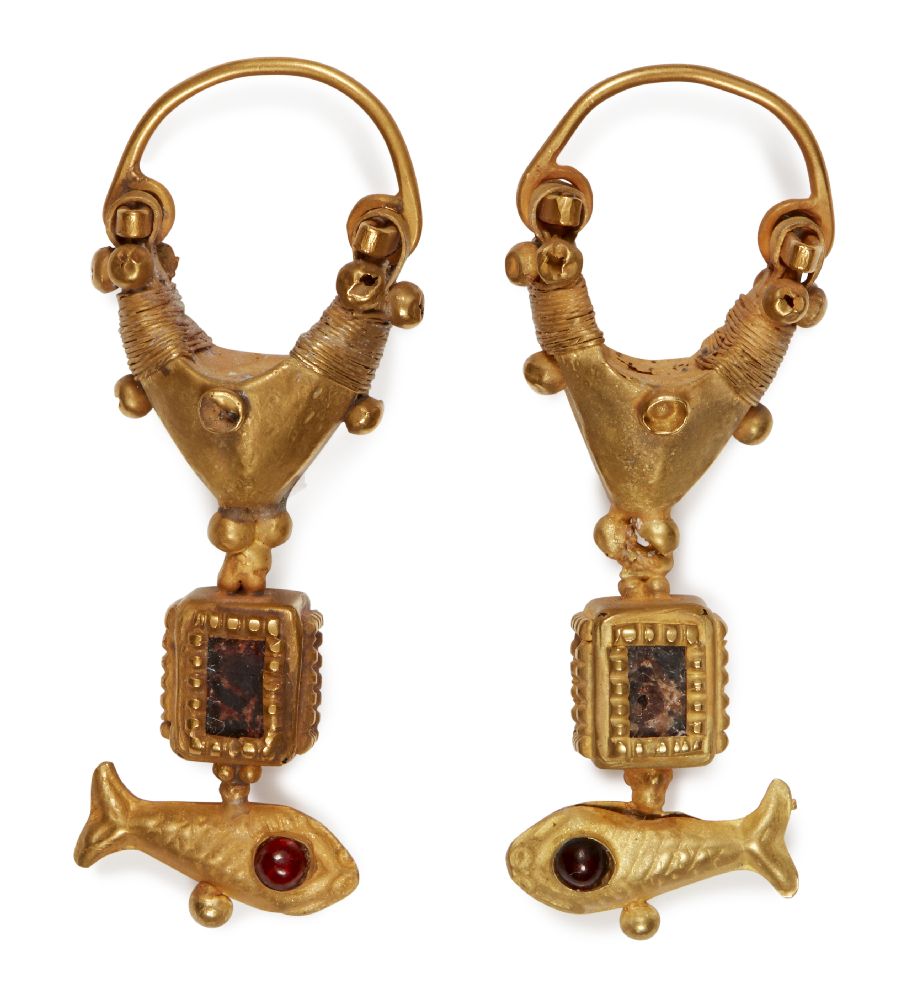A pair of garnet-set gold earrings with fish, 2nd century B.C. -1st century A.D., the suspension