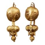 A pair of gold earrings depicting fertility icons, Iran, 10th century, composed of a series of