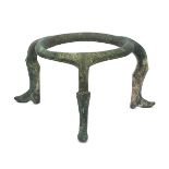 An Amlash bronze tripod, 1st millenium B.C., the ring base atop curved legs running down to boot-